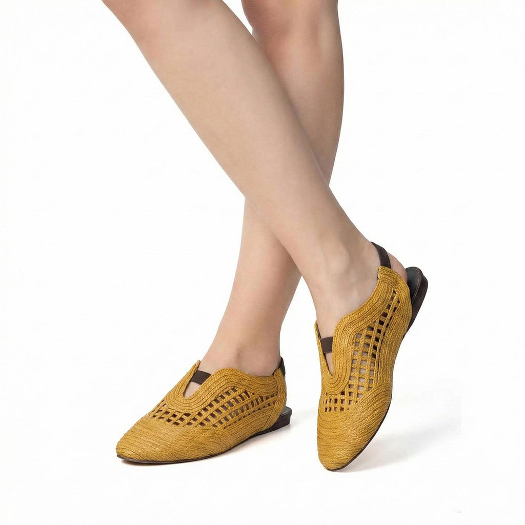 Woman wearing mustard Antelope J02 Daisy woven leather closed toe flats